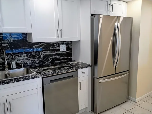 a stove top oven sitting inside of a kitchen