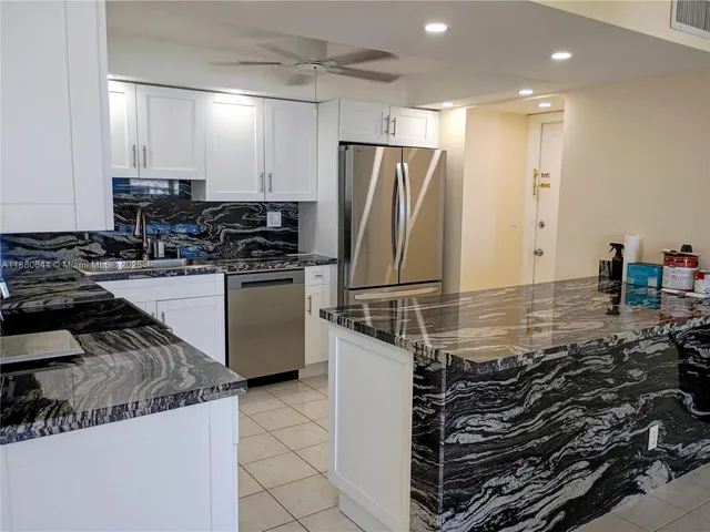 a kitchen with a sink a stove and cabinets