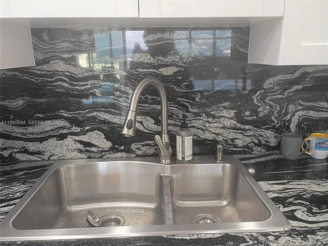 a view of outdoor living space with patio furniture and potted plant