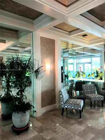 a living room with furniture and flowers