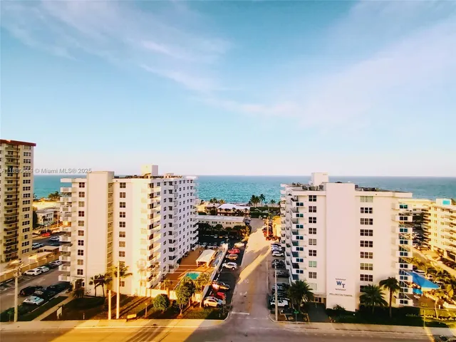 an empty room with kitchen view