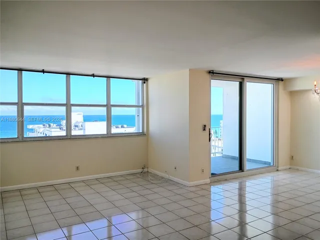 a view of a livingroom with wooden floor and a window