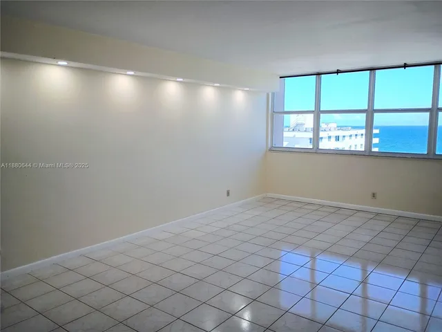 a view of an empty room with a window