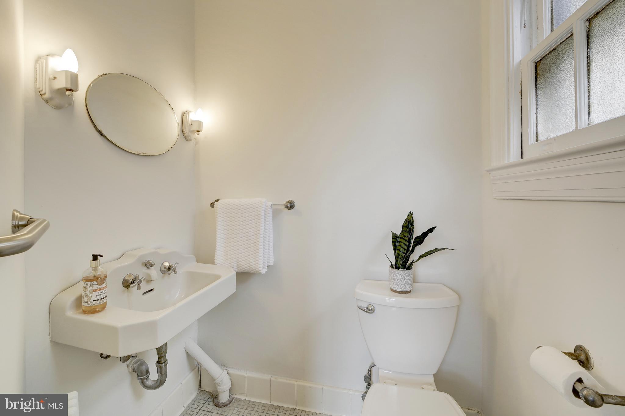 2849 29th Street Northwest Washington, DC 20008 - Photo 16 of 38 a bathroom with a sink a toilet and mirror