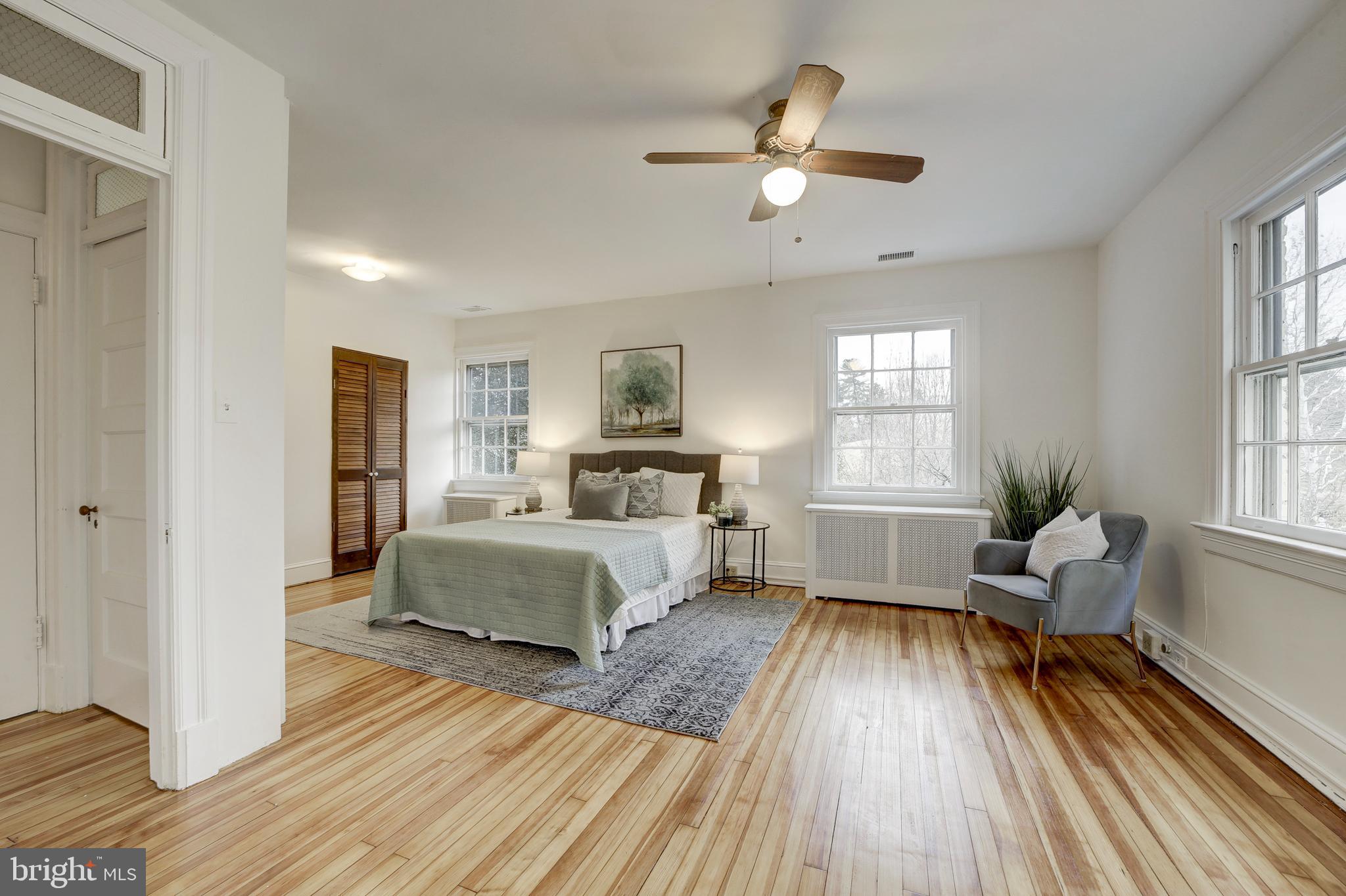 2849 29th Street Northwest Washington, DC 20008 - Photo 20 of 38 a spacious bedroom with a bed and wooden floor