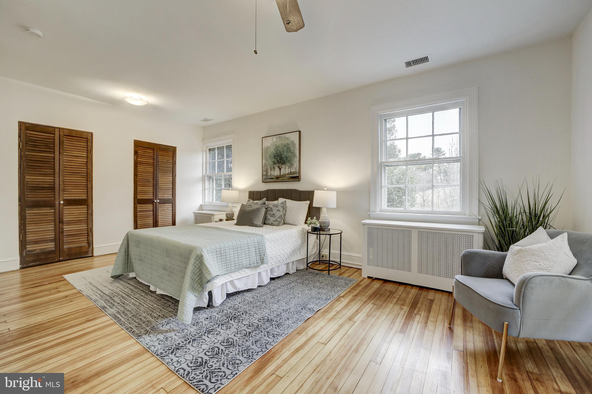 2849 29th Street Northwest Washington, DC 20008 - Photo 21 of 38 a bedroom with a large bed a rug and a window