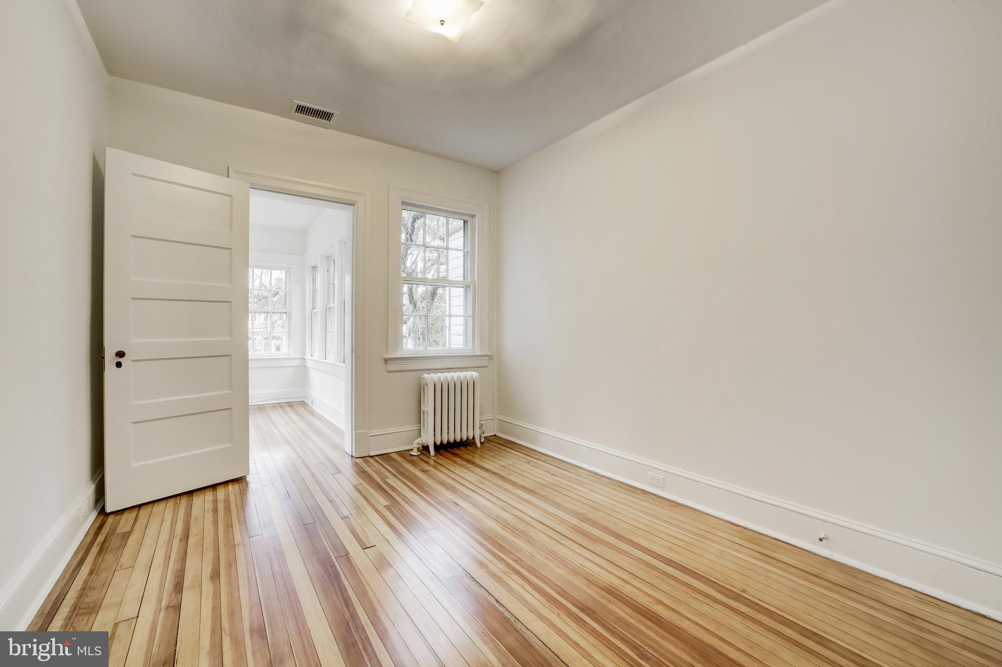 2849 29th Street Northwest Washington, DC 20008 - Photo 27 of 38 wooden floor in an empty room with a window