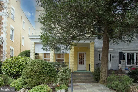 front view of a house with a tree