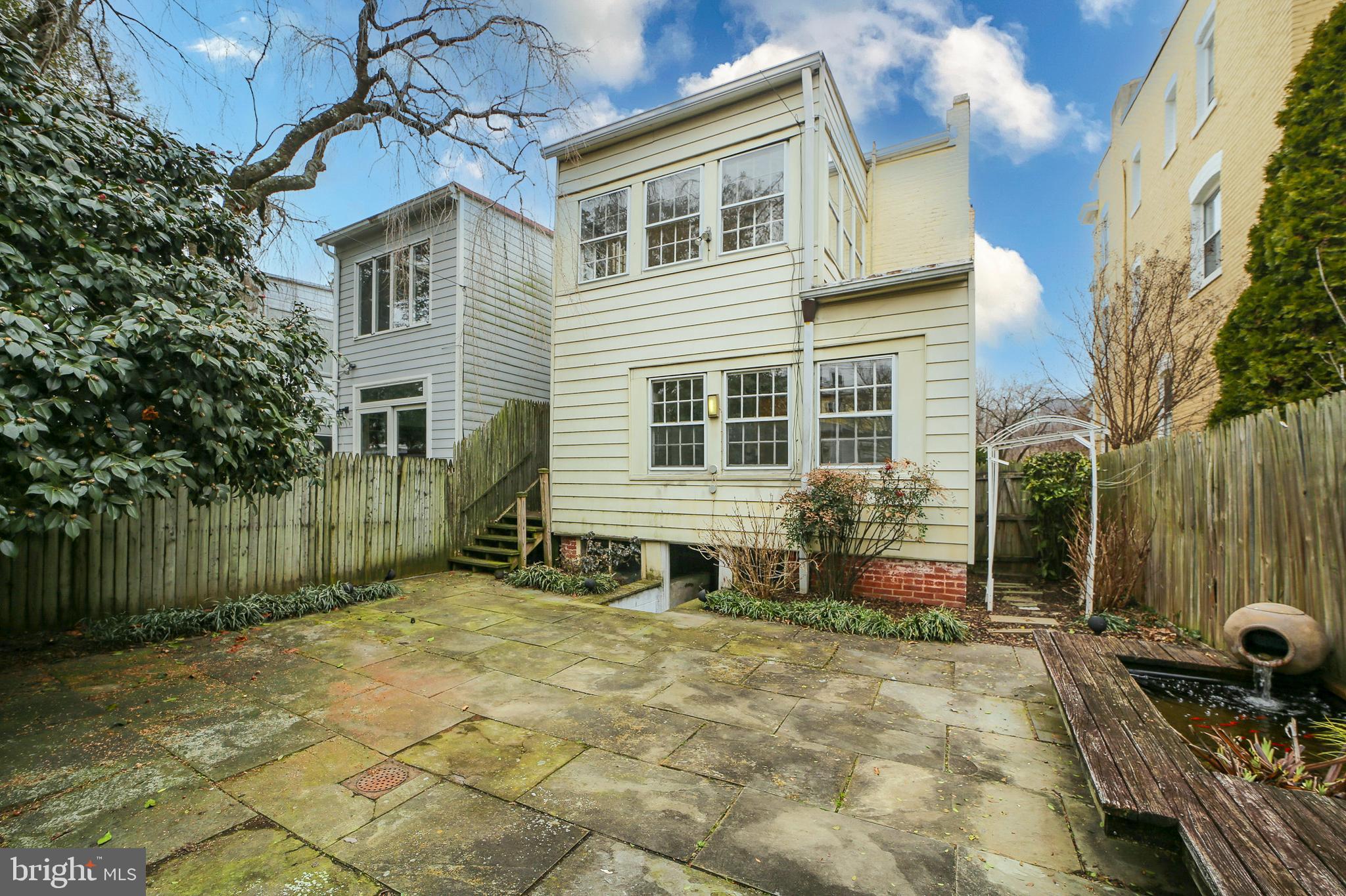 2849 29th Street Northwest Washington, DC 20008 - Photo 37 of 38 a front view of a house with a garden