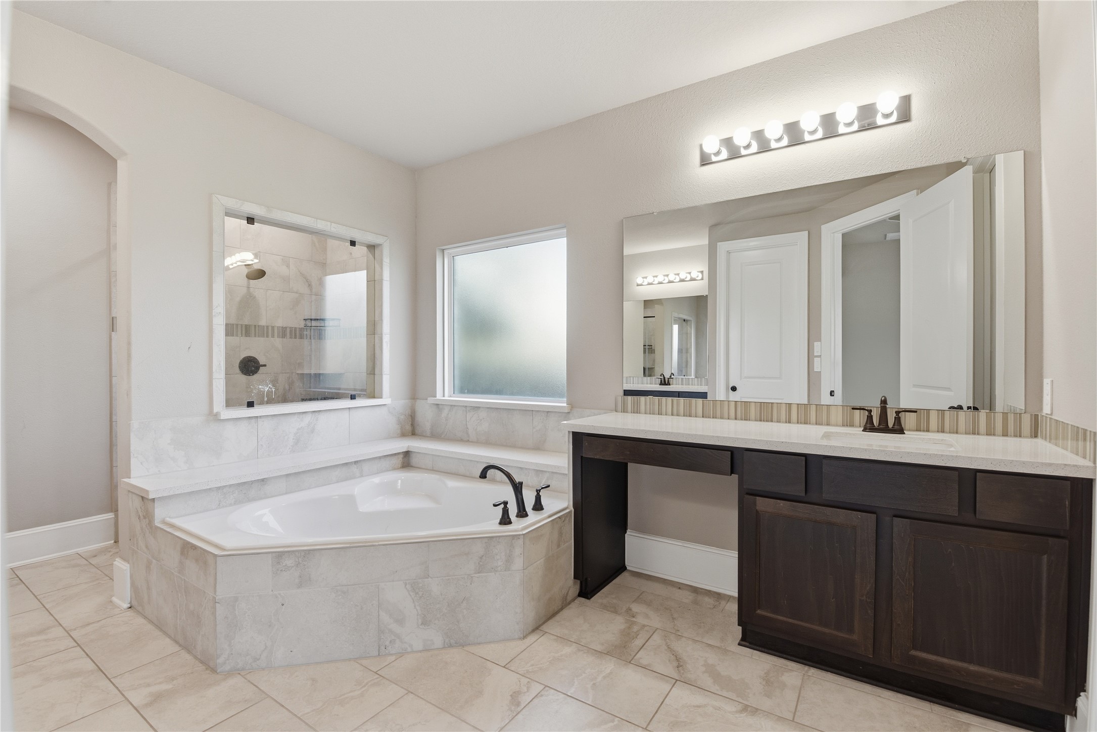 17501 Spice Merlot Lane Conroe, TX 77302 - Photo 27 of 50 a bathroom with a tub a sink double vanity and a mirror