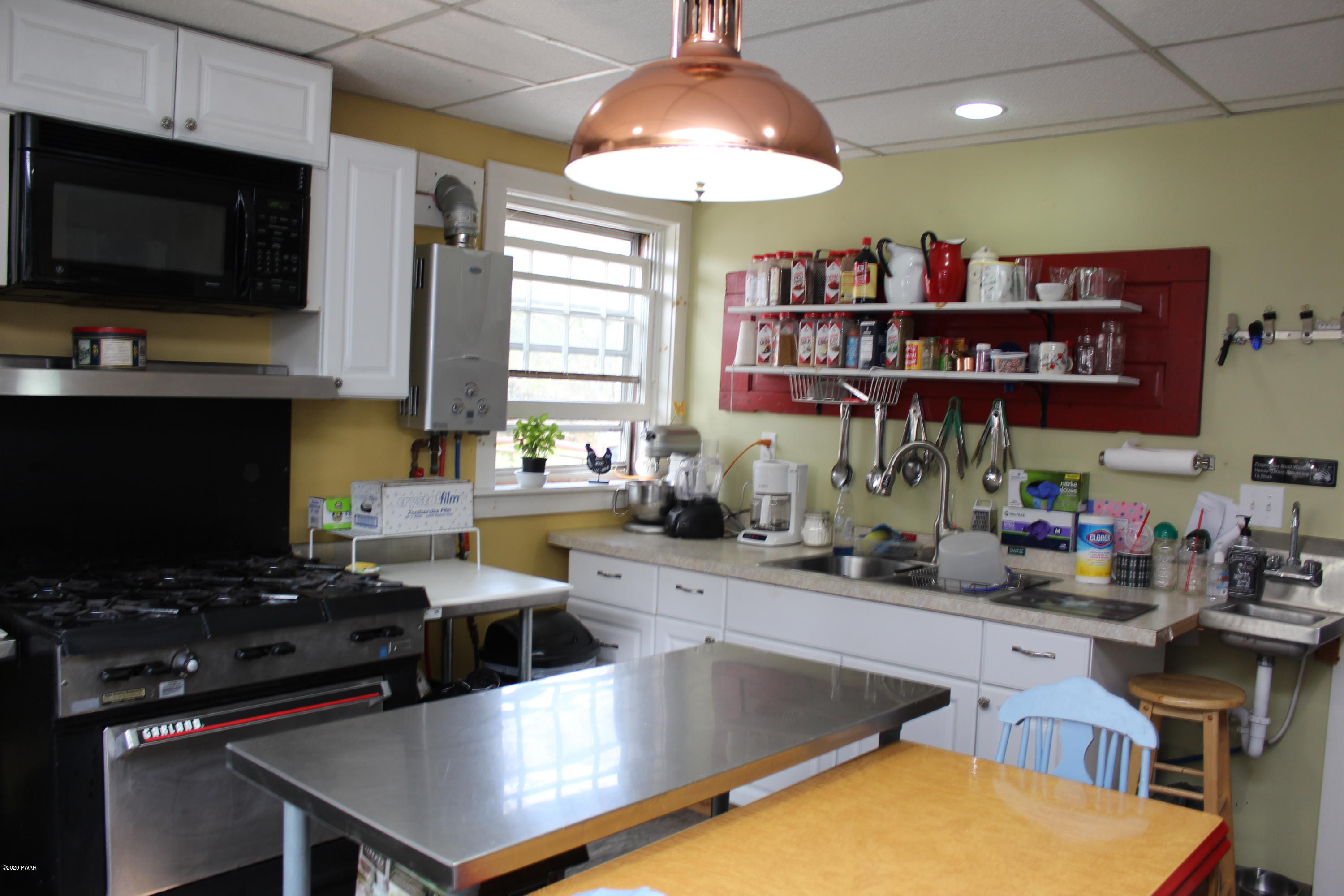 798 Goose Pond Road Lake Ariel, PA 18436 - Photo 43 of 47 a kitchen with stainless steel appliances a stove a sink and a microwave