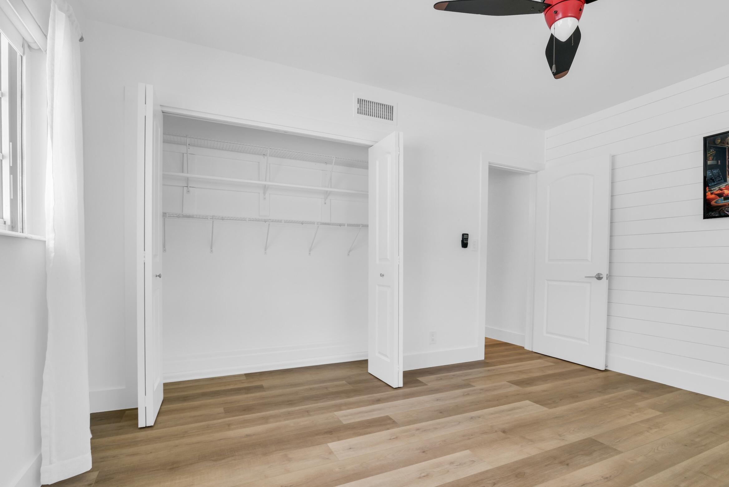 701 Appleby Street Boca Raton, FL 33487 - Photo 35 of 47 a view of an empty room with wooden floor and windows