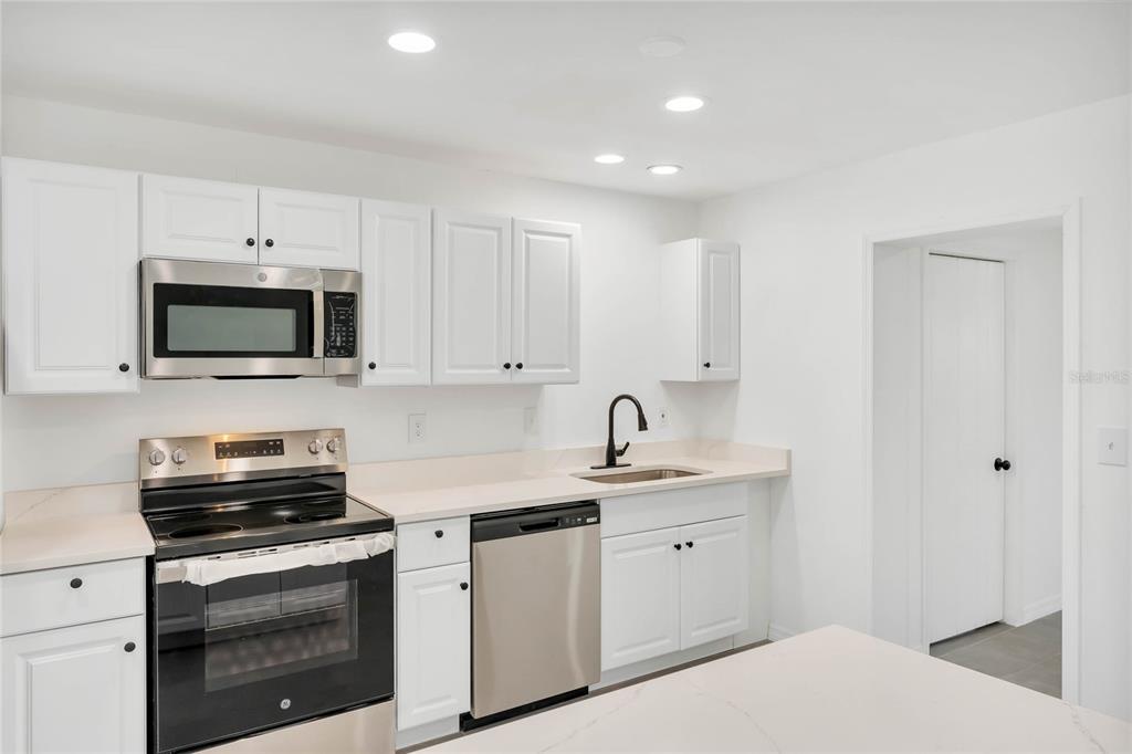 448 Ridge Drive Sanford, FL 32773 - Photo 4 of 20 a kitchen with appliances a sink and cabinets