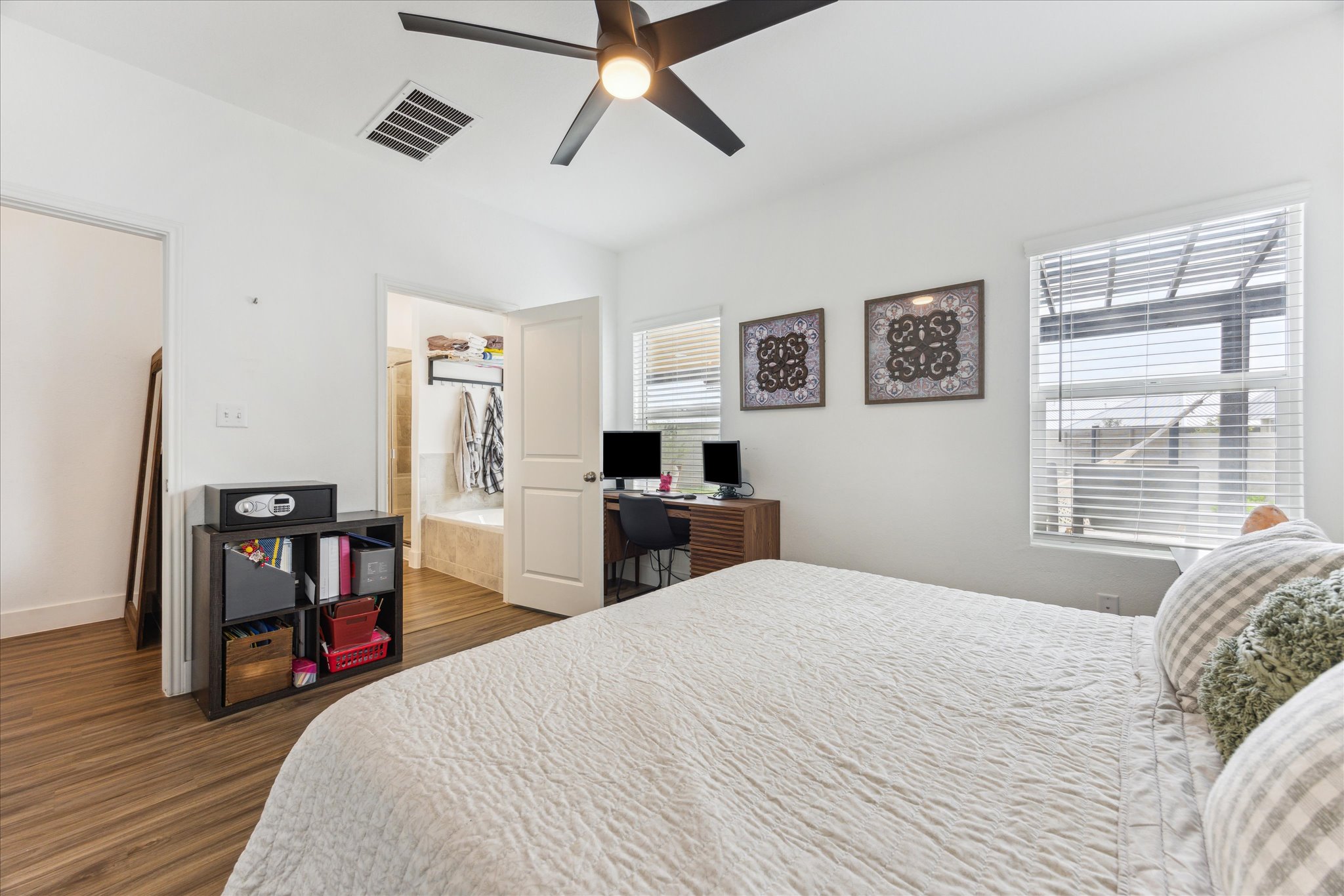 700 Legends Lane Georgetown, TX 78628 - Photo 15 of 31 Bedroom with a desk, dark wood-style floors, and multiple windows