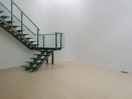 a living room with table and stairs