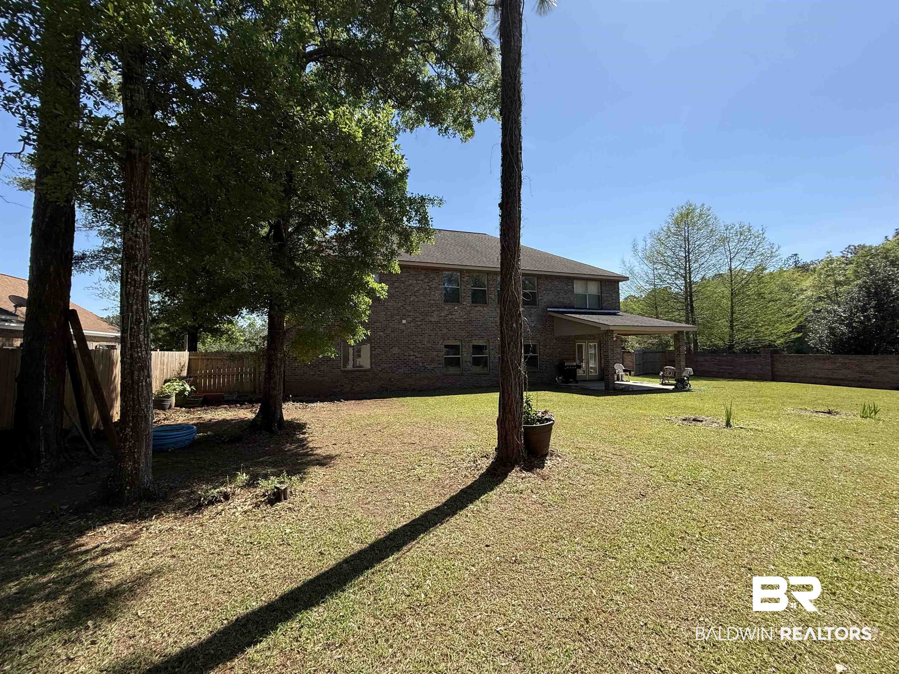 9023 Krystal Ridge Court Daphne, AL 36526 - Photo 36 of 41 Back of property with a fenced backyard, a patio area, and brick siding