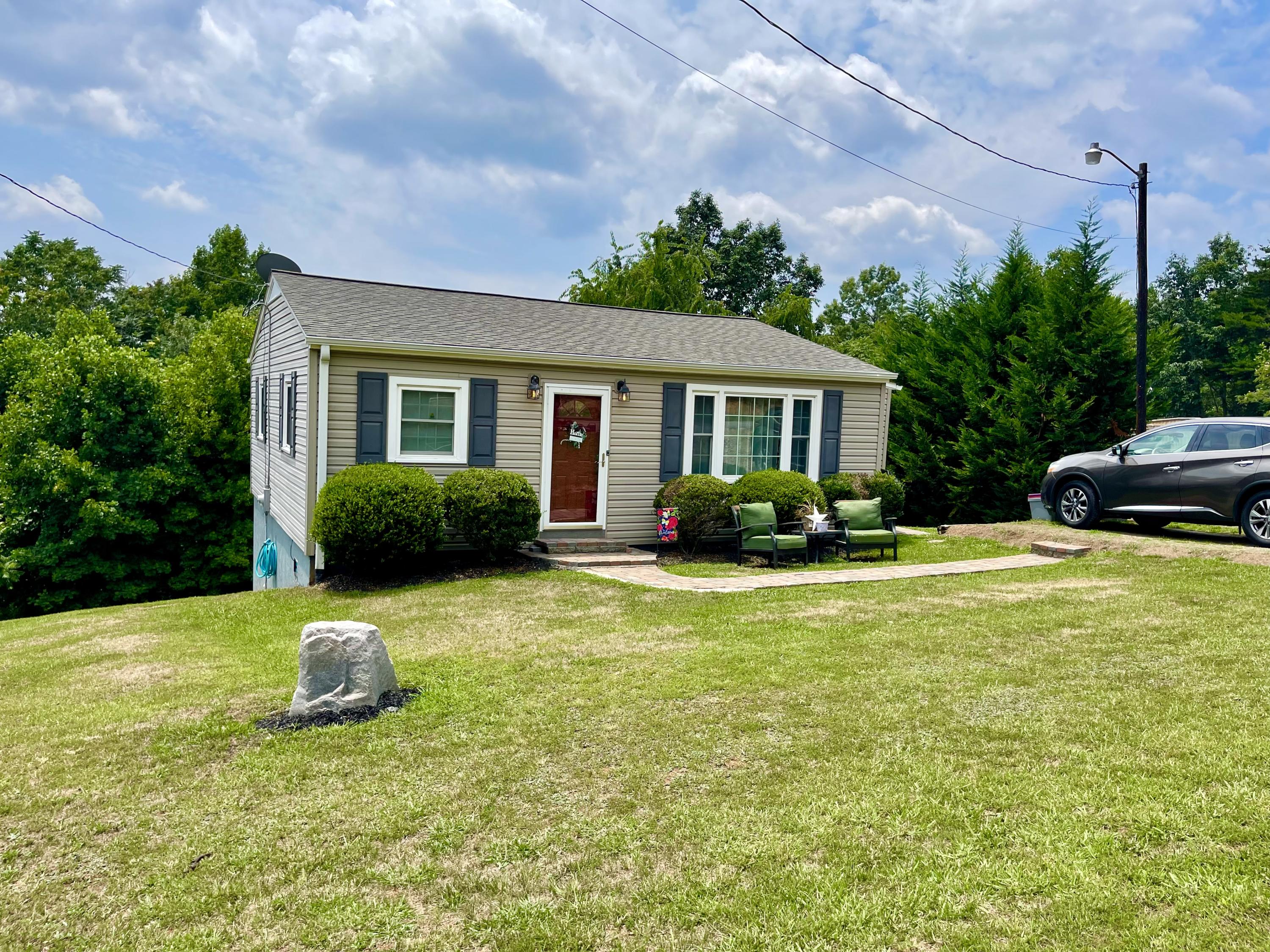 171 Oak Forest Road Bassett, VA 24055 - Photo 2 of 13 a house view with swimming pool and garden