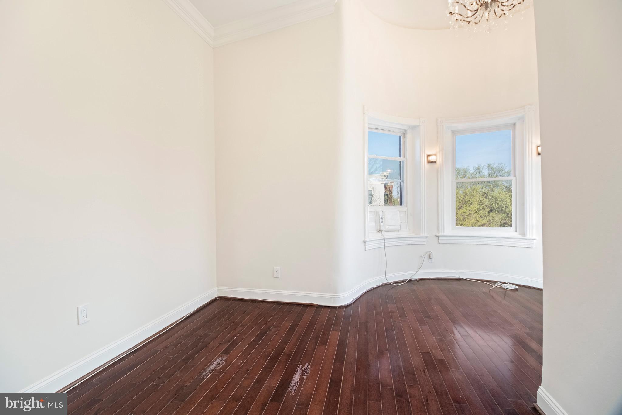 801 East Capitol Street Southeast Washington, DC 20003 - Photo 12 of 29 a view of an empty room with wooden floor and a window