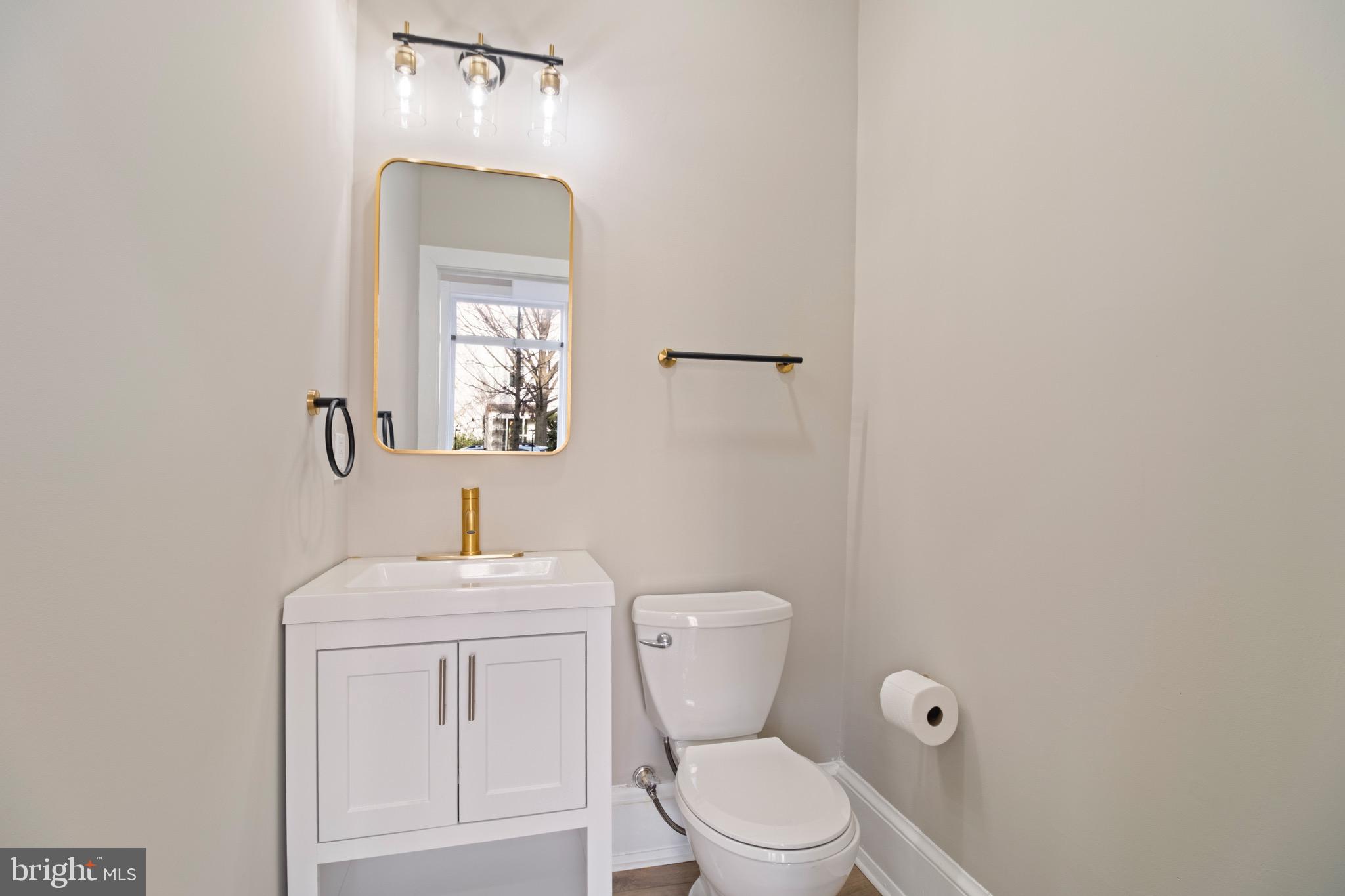 801 East Capitol Street Southeast Washington, DC 20003 - Photo 23 of 29 a bathroom with a toilet sink and mirror