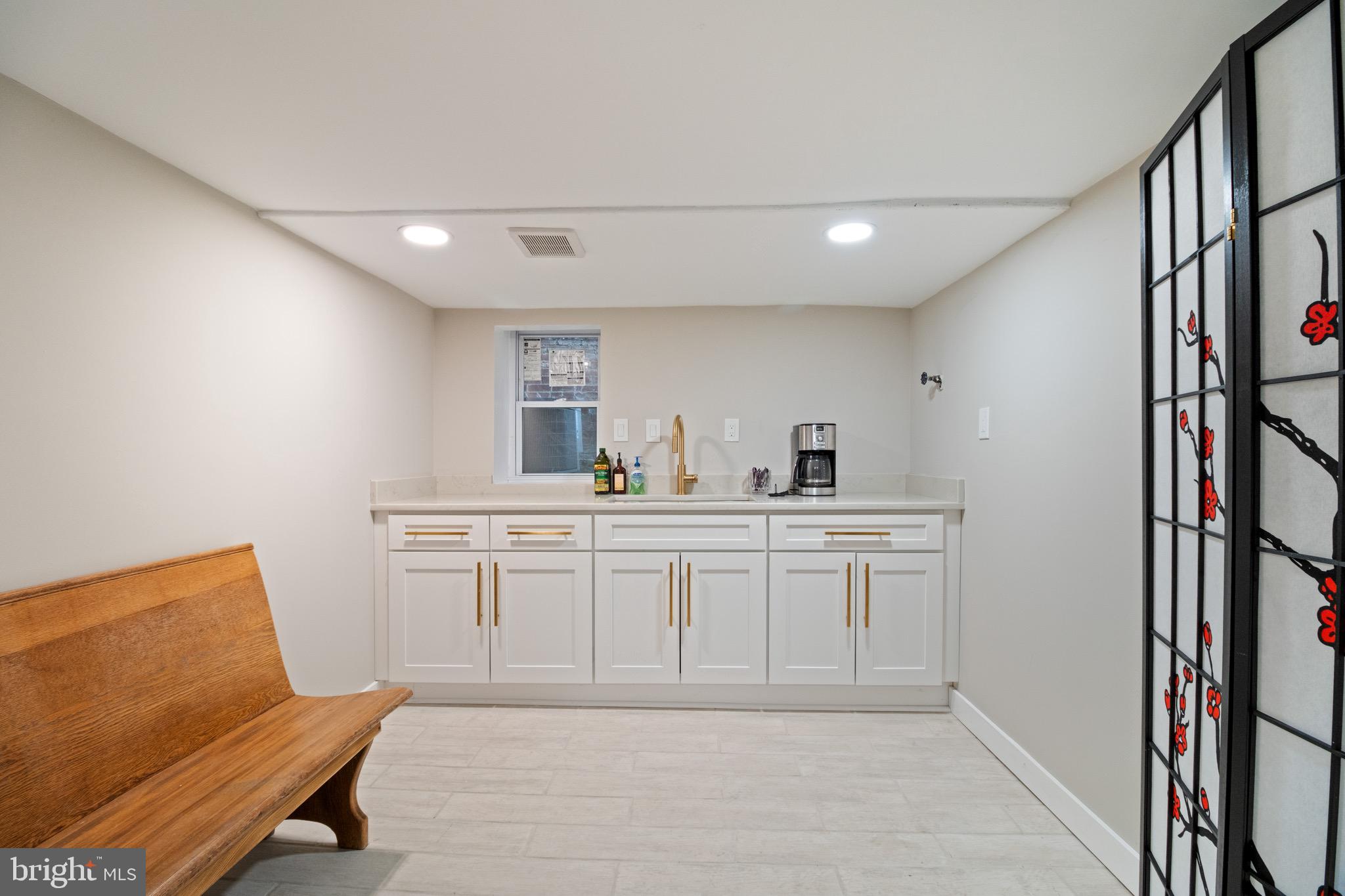 801 East Capitol Street Southeast Washington, DC 20003 - Photo 26 of 29 a kitchen with white cabinets and sink