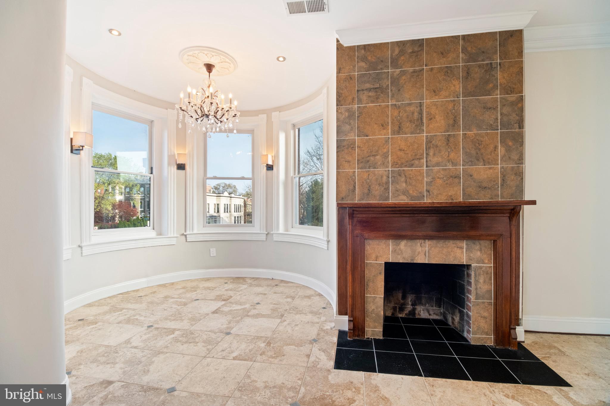 801 East Capitol Street Southeast Washington, DC 20003 - Photo 6 of 29 a living room with a rug and a fireplace