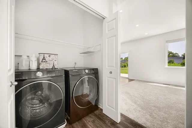 a utility room with sink dryer and washer