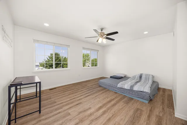 a living room with a bed furniture and a window