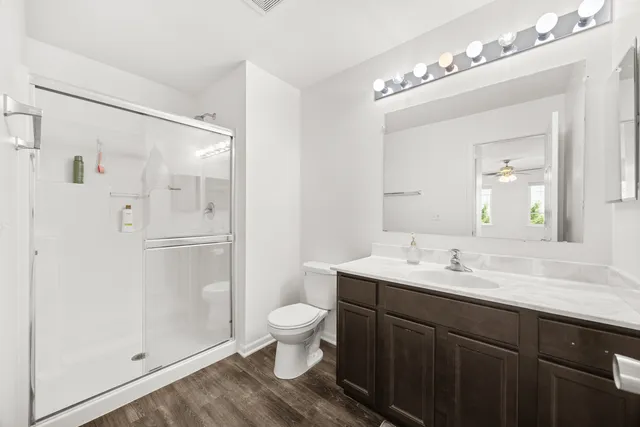 a bathroom with a double vanity sink mirror and toilet