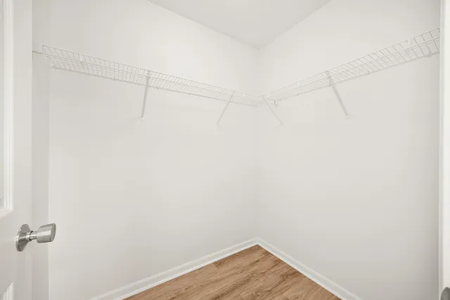 a view of a room with wooden floor