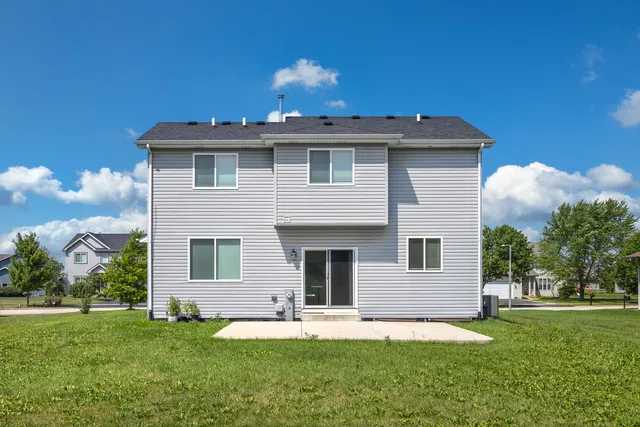 a front view of a house with a garden and yard
