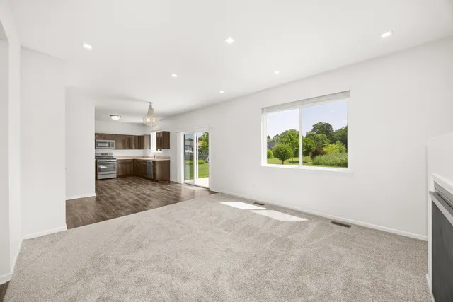 an empty room with windows and entrance