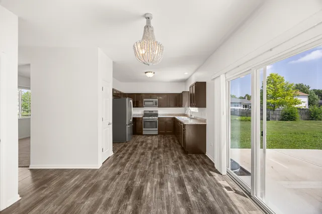 a view of a kitchen with sink stainless steel appliances and cabinets