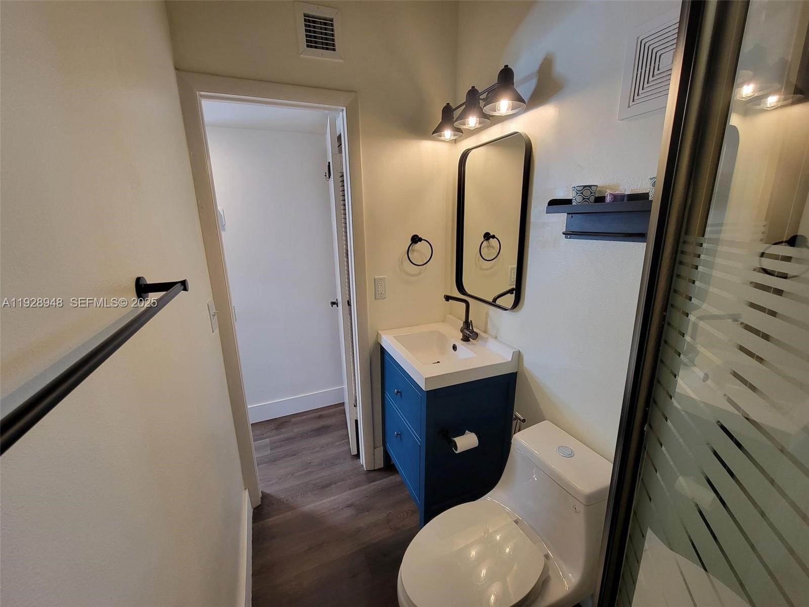 11375 Southwest 112th Cir Lane South Miami, FL 33176 - Photo 13 of 55 a bathroom with a toilet sink and mirror