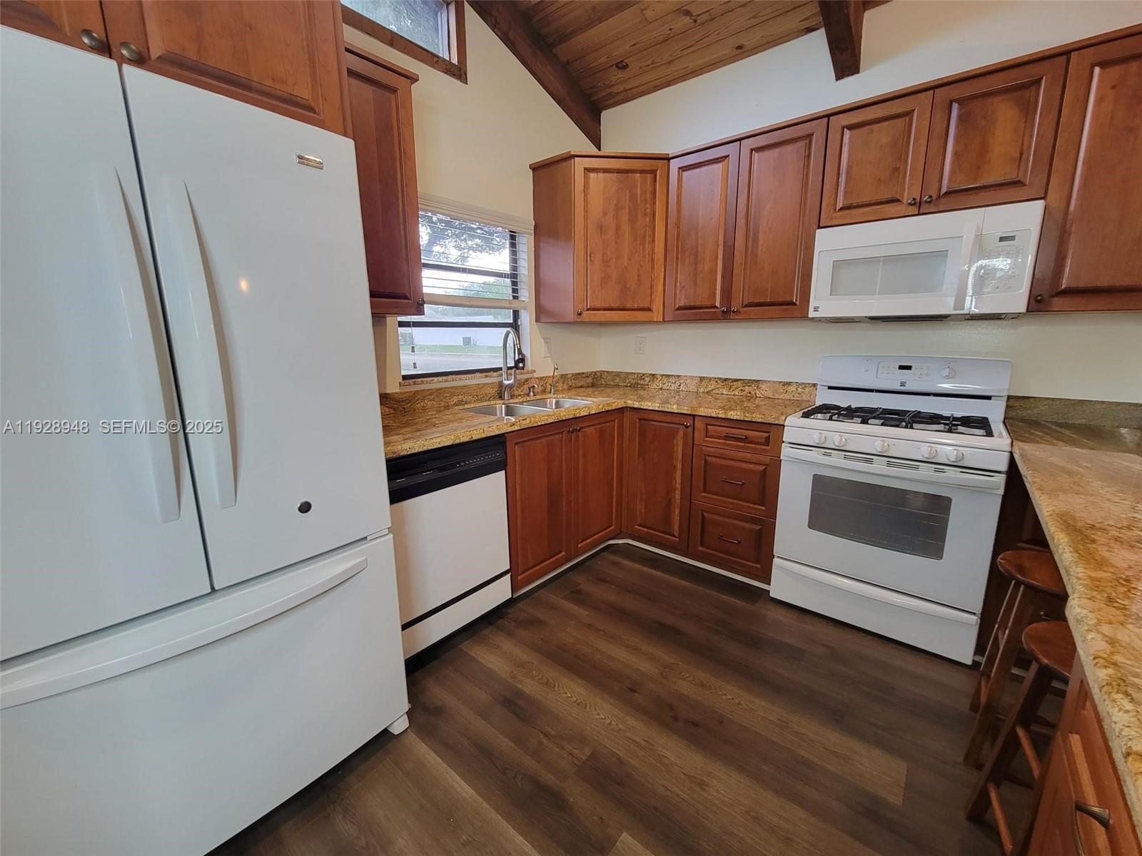 11375 Southwest 112th Cir Lane South Miami, FL 33176 - Photo 21 of 55 a kitchen with stainless steel appliances granite countertop a stove a sink and a refrigerator