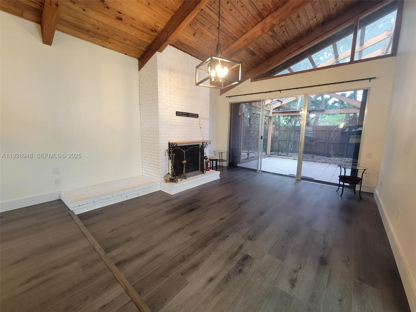 11375 Southwest 112th Cir Lane South Miami, FL 33176 - Photo 25 of 55 a view of empty room with wooden floor and fireplace