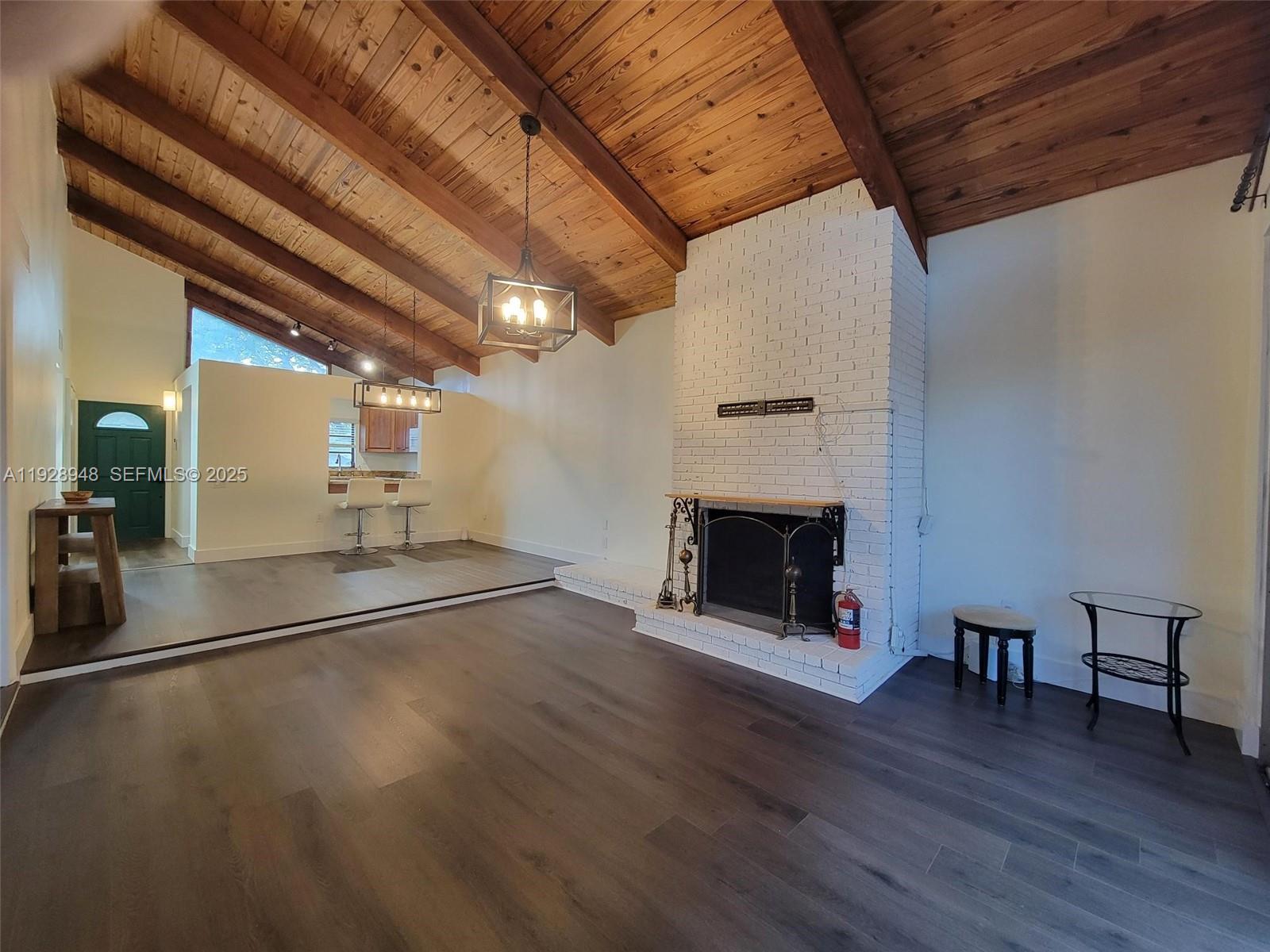 11375 Southwest 112th Cir Lane South Miami, FL 33176 - Photo 30 of 55 a view of a livingroom with wooden floor and a fireplace