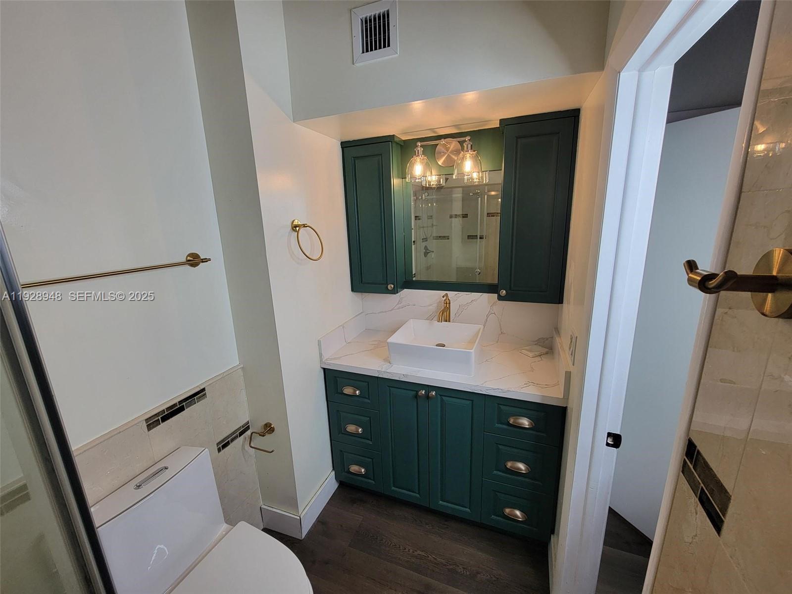 11375 Southwest 112th Cir Lane South Miami, FL 33176 - Photo 39 of 55 a bathroom with a sink a toilet and mirror