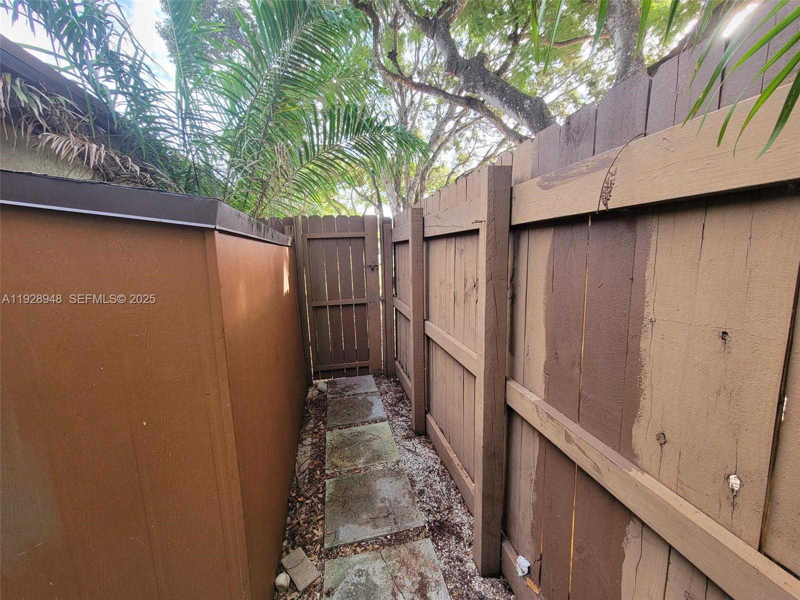 11375 Southwest 112th Cir Lane South Miami, FL 33176 - Photo 50 of 55 a view of a small yard with wooden fence