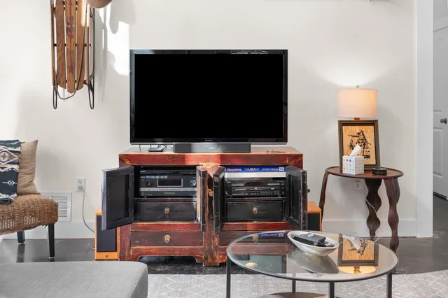 a living room with furniture and a flat screen tv