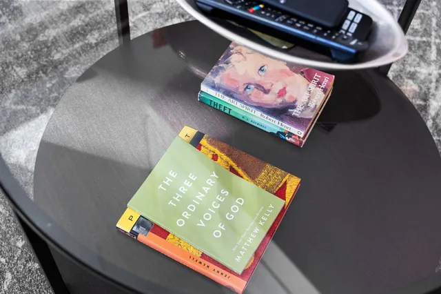 a open kitchen with stainless steel appliances kitchen island granite countertop a table chairs and a refrigerator