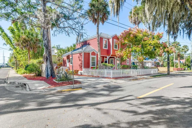 a front view of a house with a yard and tree s