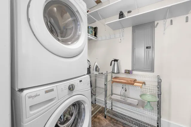 a view of a room with a chandelier furniture and windows