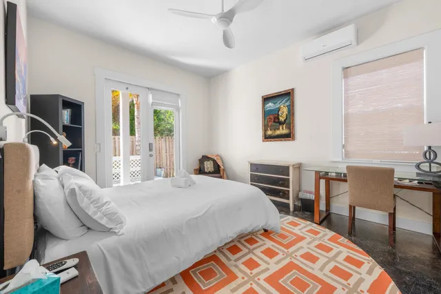 a bedroom with a bed and a flat screen tv