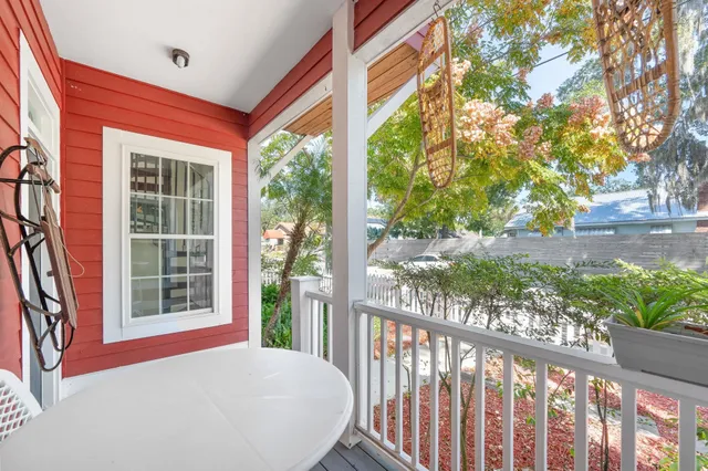 a living room with furniture a flat screen tv and a large window