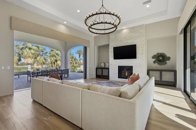 a kitchen with a dining table chairs and living room view