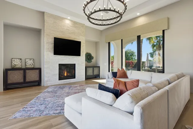 a view of a dining room with furniture a chandelier and wooden floor