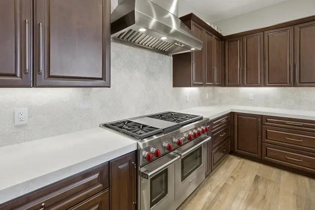 a bathroom with a double vanity sink a mirror and a bathtub