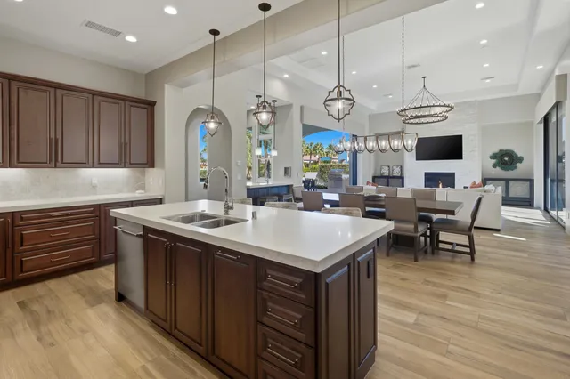 a bedroom with a bed a chair and potted plant on the table