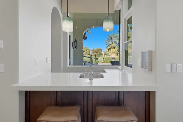 a bathroom with a shower sink and mirror