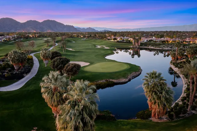 a view of a garden with a slide and a lake view